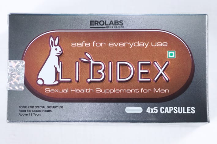 Nutraceutical supplement capsules and product packaging on a lab bench